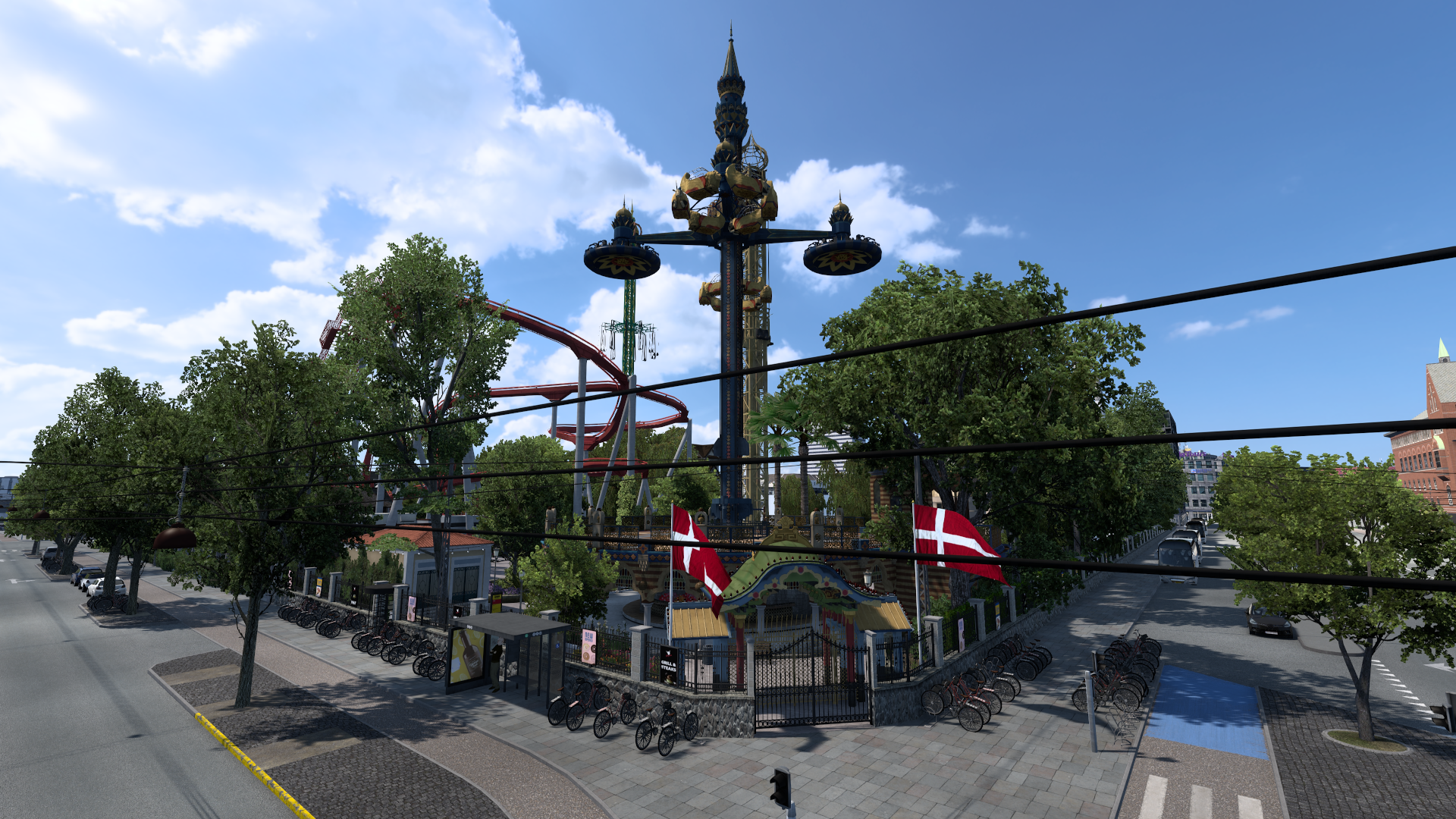 Eingangsbereich Tivoli in Kopenhagen mit Fahrgeschäften und Flaggen